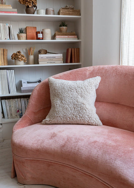 Sheepskin cushion styled on sofa