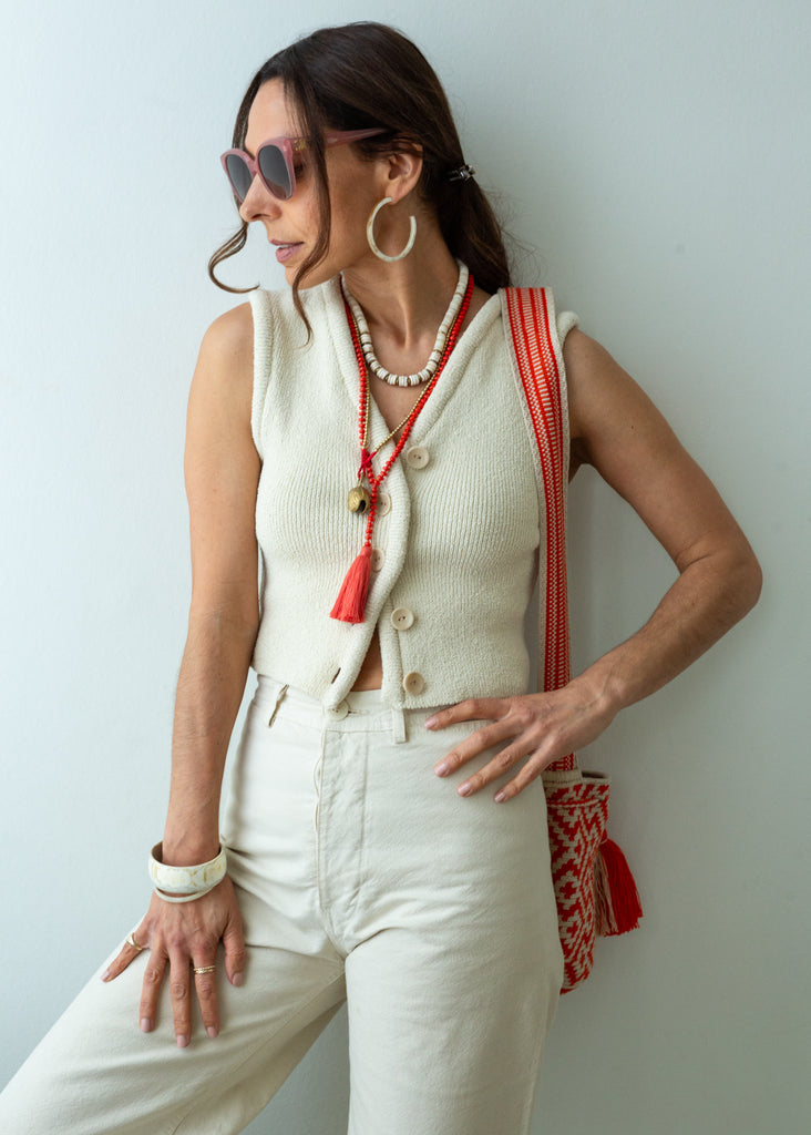 Long beaded red tassel necklace, layered with other necklaces
