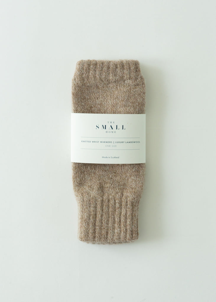 A pair of folded ribbed knit socks in a heathered taupe-brown color, wrapped with a white paper label that reads 'THE SMALL HOME'. The product is photographed flat on a clean, light off-white background.