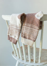 two pairs of fair isle socks over a chair