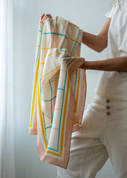Person holding a colorful scarf against a light background