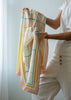 Person holding a colorful scarf against a light background