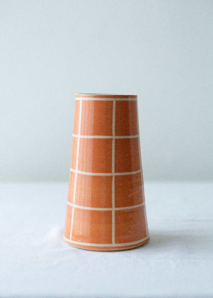 orange handmade vase with grid pattern 