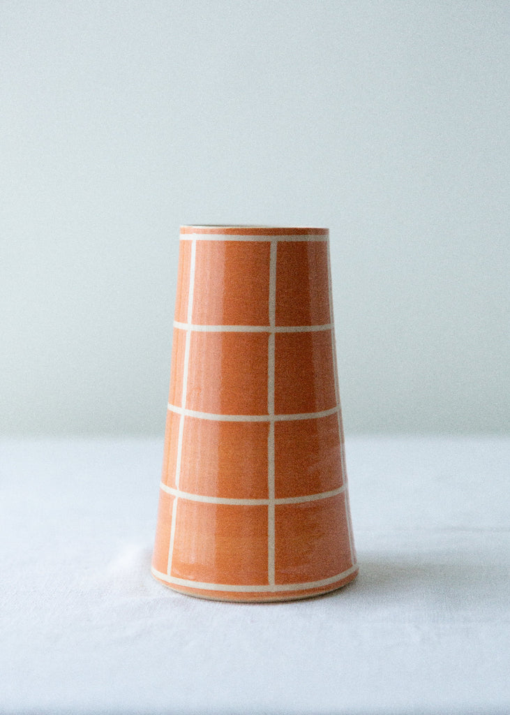 orange handmade vase with grid pattern 