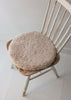 Natural sheepskin seat pad in soft oatmeal, with inner foam cushion and non-slip microfibre base