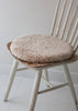 Natural sheepskin seat pad in soft oatmeal, with inner foam cushion and non-slip microfibre base