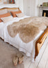 quatro sheepskin rug over a kingsized bed