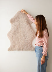 short wool curly sheepskin rug in an oatmeal colour