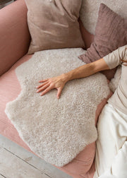 short wool curly sheepskin rug in an oatmeal colour