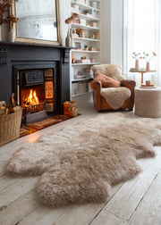 large sheepskin rug by a fire