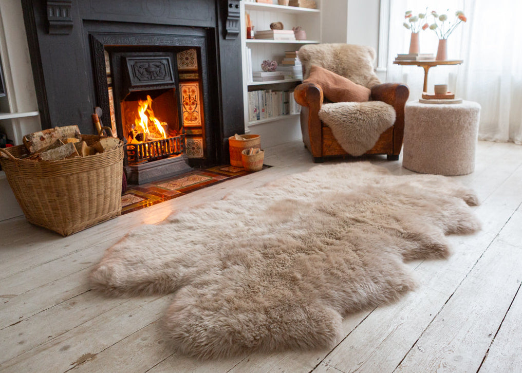 large sheepskin rug by an open fire