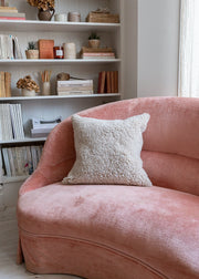 Sheepskin cushion styled on sofa
