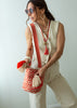 Long beaded red tassel necklace, layered with other necklaces and Medium Wayuu Bag - Eden