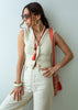 Long beaded red tassel necklace, layered with other necklaces