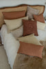 Small rectangular cushion in clay pink slubby cotton and Spiral tufted cushion in mocha linen 