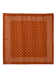 A square terracotta orange silk scarf with a white geometric pattern, featuring a central field of small white diamond motifs and a dotted border, shown flat against a white background.