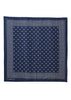 A square navy blue silk scarf with a white geometric pattern, featuring a central field of small white stars and a dotted border, laid flat on a white background.
